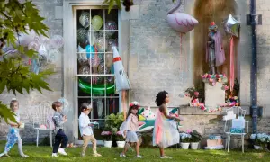 Kinder mit Geschenken und Ballons, tolle kita geburtstag ideen für eine magische Feier im Freien.