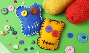 Zwei bunte Filz-Wutmonster basteln: Ein blaues mit gelbem und orangefarbenem Knopfauge, ein gelbes mit lila und rotem Knopfauge. Viele bunte Knöpfe und Garnknäuel liegen daneben.