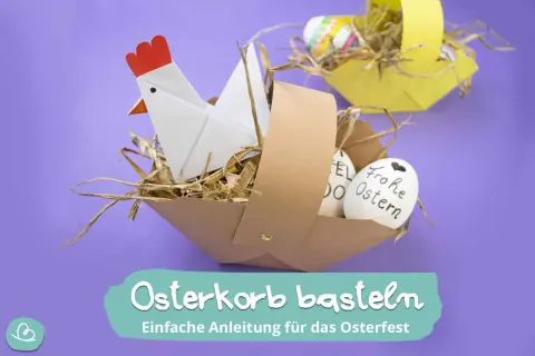Osterkorb basteln: Ein Origami-Huhn sitzt in einem selbstgemachten Korb mit Stroh und Ostereiern. Einfache Anleitung für das Osterfest.